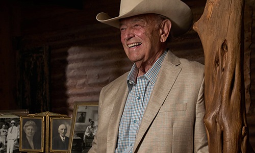 man in suit and cowboy hat